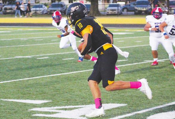 COLE McNANNA Sealy senior Thomas Clark hits the open field en route to a 45-yard interception returned for a touchdown on the second play from scrimmage during the Tigers’ district-opening contest against Royal Friday night at T.J. Mills Stadium.