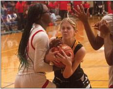 Sealy sophomore Jessica DeBerry battles down low for a rebound during the Lady Tigers contest with Royal last Friday night. PHOTOS BY JIMMY GALVAN
