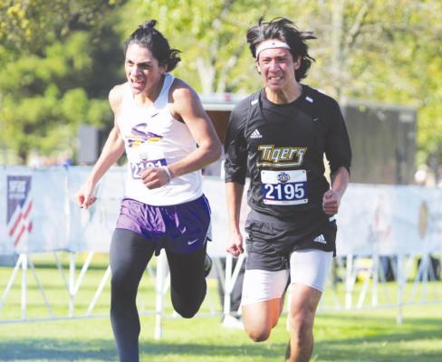 Sealy senior Daniel Medrano battles Sanger’s Jose Rojas at the finish line of the Class 4A State Championship meet at Old Settlers Park in Round Rock. COLE McNANNA