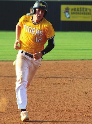 Tiger senior Rhys Reichardt gets the wave to round third and head home during Sealy’s playoff warmup game against Kempner at Aubrey “Mutt” Stuessel Stadium Monday evening. COLE McNANNA