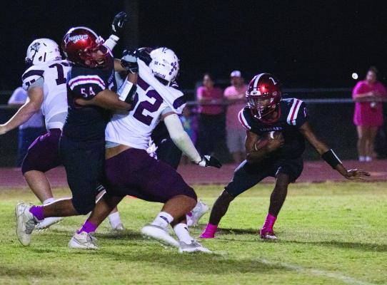 Brazos’ Bryson Bennett breaks behind a key offensive block for running room against East Bernard. Brazos defeated the Brahmas 31-13 to move to 2-1 in district play. PHOTOS BY JIMMY GALVAN