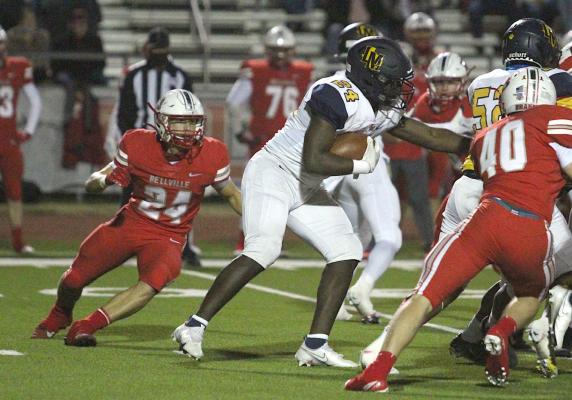 Bellville senior Garrett Babylon (24) bears down on La Marque running back Brandon Jones (24) in a district contest between the Brahmas and Cougars at the Pasture of Pain in Bellville on Oct. 30. Babylon landed on the second team academic all-state and led the team with 137 total tackles in his final season for the Brahmas. Cole McNanna