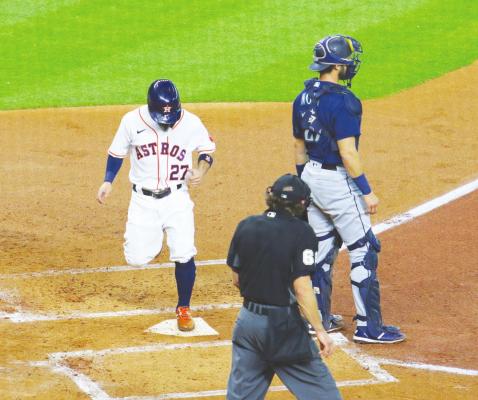 Houston second baseman Jose Altuve touches home to score a run during the Astros’ game against the Seattle Mariners July 25, 2020, at Minute Maid Park. In the last month, Altuve has led the team with eight home runs. FILE PHOTO