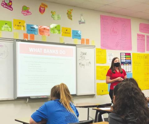 Industry State Bank’s Marketing Manager Rachel Kozel presents banking basics to students at Sealy Junior High School during a recent visit. CONTRIBUTED PHOTO