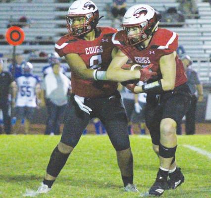 Brazos senior Noah Gregory takes a handoff from sophomore quarterback Ja’vien Dickerson in the first half of the Cougars’ homecoming game against St. Joseph last Friday night in Wallis. PHOTOS BY COLE McNANNA