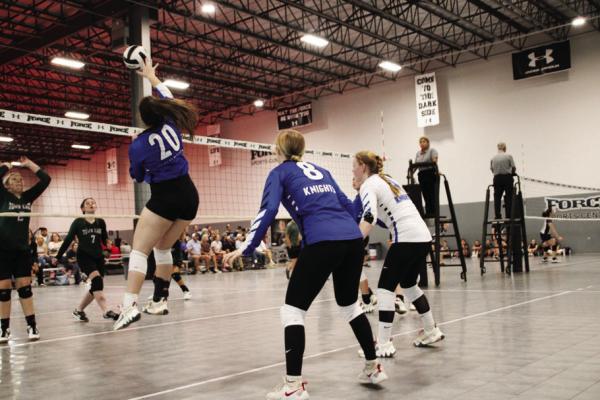 Alyza Marcotte (20) spikes a return during a game during the regional championships. Also pictured are Payton Schulze and Jayme Perkins. COURTESY PHOTO