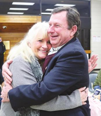 City Manager Lloyd Merrell and his wife Marsha embrace after Merrell gave the Sealy City Council his resignation and they had gone into executive session to deliberate his employment.