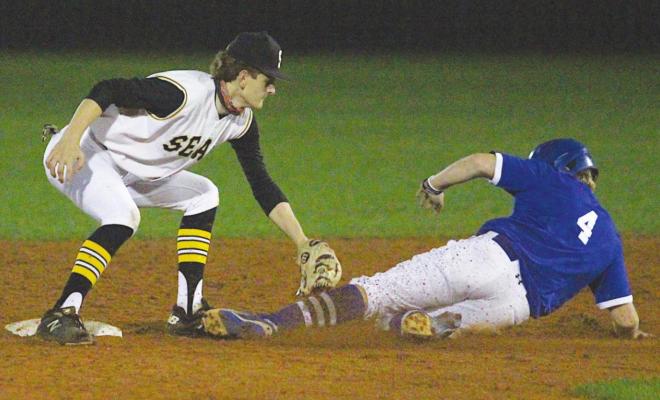 Tiger sophomore Garret Nedd applies the tag after a throw from catcher Dylan Aguado that caught a Needville baserunner trying to steal second during last Tuesday’s district contest at Aubrey”Mutt"Stuessel Stadium. COLE McNANNA