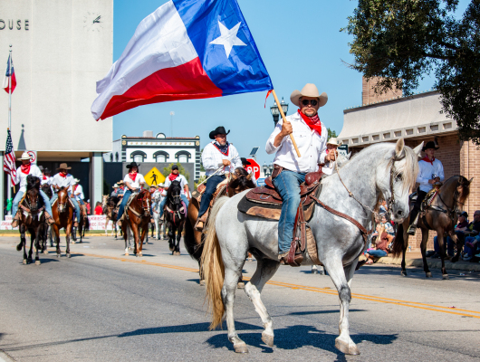 The Coshatte Amigos prance on horses during the Austin County Fair opening parade, Thursday, Oct. 9, through Bellville. Sealy News | Allison Drinnon