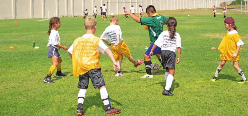 Students at the Sealy Soccer Camp competing for the ball last Wednesday June 29 at Sealy High School. JASON MANAGO-GRAVES