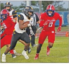 Sealy running back Bryson Johnson looks for running room and is chased by Brookshire’s Jeremiah Randolph during last Friday’s contest. Brookshire held off Sealy 13-10 to claim the district win. PHOTO BY JIMMY GALVAN