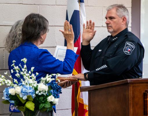 Sealy Mayor Carolyn Bilski (left) and Marcy Grimes formally swear in Russell Grimes as the new chief of police, Wednesday, Oct. 1, at the W. E. Hill Community Center. Sealy News | Allison Drinnon