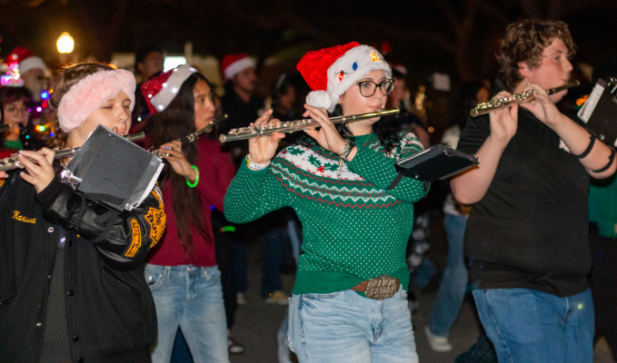7.	Sealy ISD flutists Karrissa Harding (left), Madyson St. Clair and Jaylon Pauley march while performing in the Fantasy of Lights festival parade, Saturday, Dec. 6, in Sealy.
