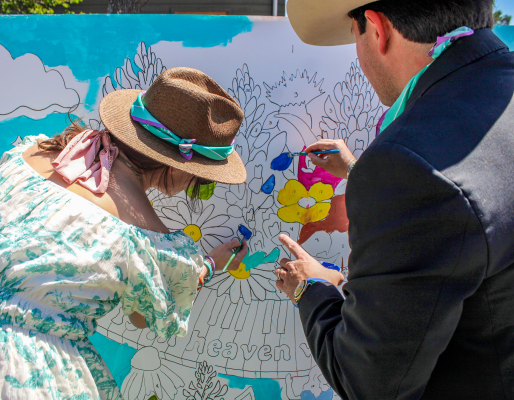 Lacey and Lars Hollis, parents of Virginia Hollis, paint a community mural during Virginia’s 9th Birthday Celebration & Fundraiser, Saturday, March 21, at The Compound in Round Top. Virginia, a camper at Camp Mystic, died during the July 2025 Central Texas floods.