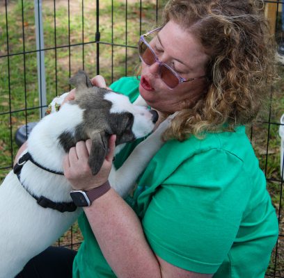 Catherine Newlin kisses Nori, a rescue dog, at Belles Buds Rescue's “Lucky Paws & Waggin' Tails Adoption Event,” Saturday, March 21, at the Sealy Farmers Market. ALL PHOTOS BY THE SEALY NEWS | EVAN HALE