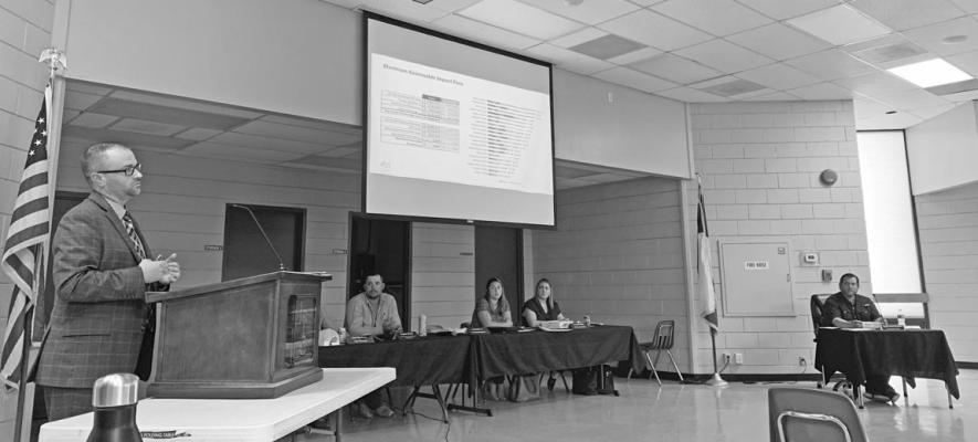 Ryan Tinsley of Strand Associates presents data regarding impact fees. PHOTO BY ABENEZER YONAS
