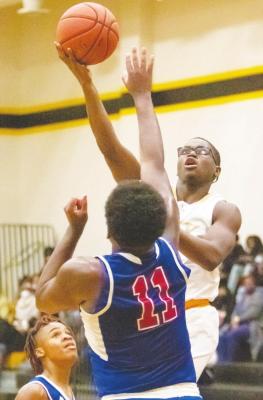 Sealy junior A’vonte Nunn glides through the lane for a layup in the second half of the Tigers’ district tilt with Royal last Friday at home. COLE McNANNA