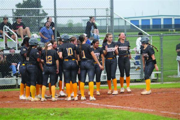 Kara Kram (far right) celebrates her home run by dancing into a group hug from her teammates. SEALY NEWS | EVAN HALE