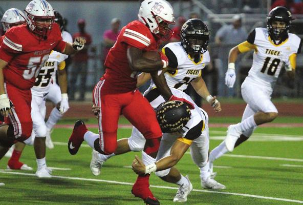 Bellville senior running back Richard Reese meets with Sealy senior defensive back Connor Krenek on an outside run during last Friday’s rivalry matchup in the Pasture of Pain. COLE McNANNA
