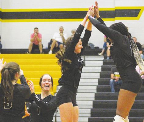 COLE McNANNA Annabelle Williams (4) and Jasmyne Joiner (13) celebrate one of Williams’ three aces during Sealy’s district contest against El Campo last Tuesday at home.