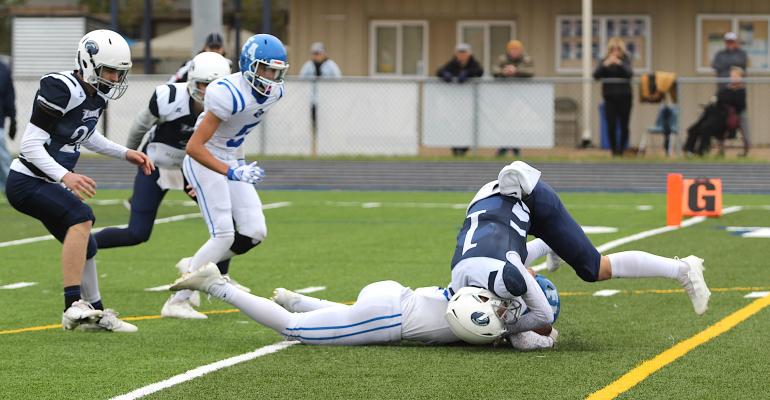 Faith Academy freshman Travis Woodley recovers a fumble from Northside senior Riley Worbington (1) in the end zone for a second-quarter score during Faith Academy’s state title game in Bryan Nov. 27. COLE McNANNA