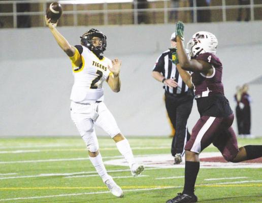 Sealy junior quarterback D’vonne Hmielewski uncorks an off-balance throw during the first half of the Tigers’ bi-district playoff game Friday night at Thorne Stadium in Aldine.