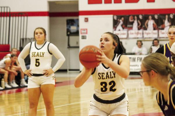 Above: Avery Balensiefer shooting and making a free throw against La Grange. Below: Elizabeth Reichardt fighting through a block to snatch a rebound up. PHOTOS BY SEALY NEWS | EVAN HALE