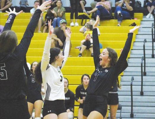 Sealy seniors Bailey Koy (3) and Katie Wagoner (7) celebrate Wagoner’s block during the Lady Tigers’ non-district finale against St. John XXIII at Sealy High School Friday afternoon. COLE McNANNA