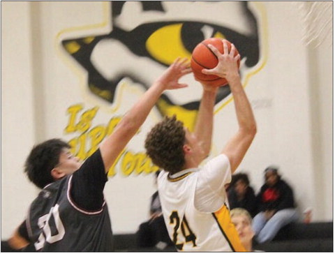 Sealy’s Garrison Ward 24 drives to the bucket for two of his 15 total points against West Columbia on Dec. 9 at the Tiger Gym. Sealy won the game 65-32 and Ward was named player of the game. HERBERT KOLLATSCHNY/NEWS
