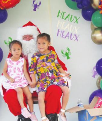 Irma and Layla Rodriguez sat on Santa’s lap and posed for a picture. PHOTO BY HANS LAMMEMAN