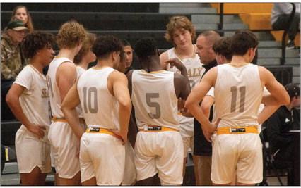 Sealy Head Boys Basketball Coach Cody Carruthers talks with his team during a timeout. Sealy is off to a bad start in district but still has the second half of district to try to it around and make a run at a playoff berth. PHOTO BY JIMMY GALVAN