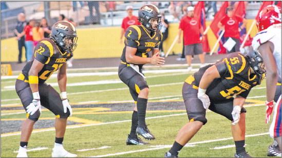 Tigers Quarterback D’vonne Hmielewski awaits the snap in shotgun formation during their matchup with the Brazosport Exporters Friday, Aug. 26. Left to right: Bryson Johnson and D’vonne Hmielewski. JASON MANAGO-GRAVES