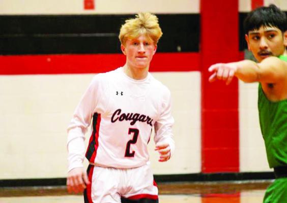CJ Kleas running down the court on a fast break.