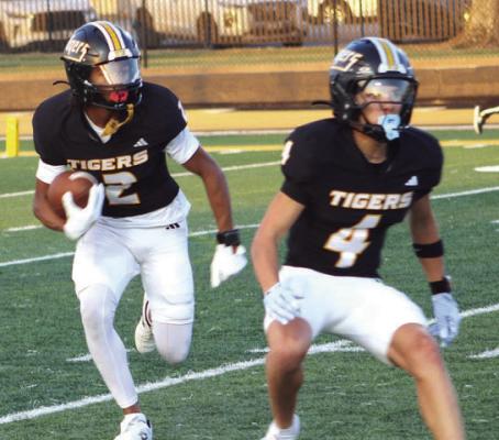 Elijah Sanders, 2, follows the blocking of Weston Cryan, 4, as he makes a nice return on the opening kickoff setting up the first Sealy touchdown.
