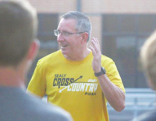 Sealy Head Cross Country Coach Anthony Branch demonstrates technique during the first practice of the year Aug. 2. Branch organized a Friday Night Lights meet in Sealy that will kick off the regular season at the end of this week. COLE McNANNA