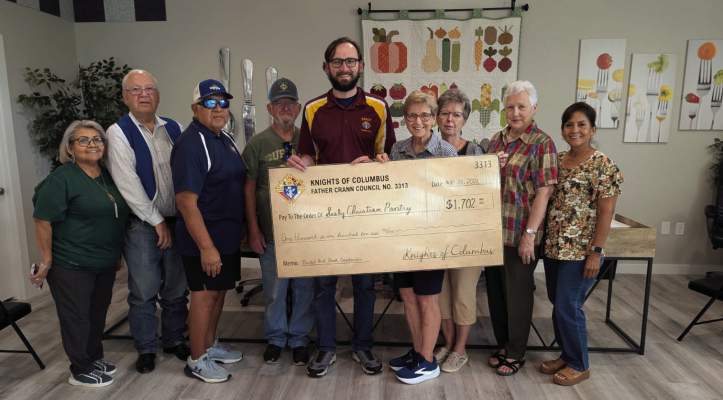Making and receiving the presentation were, from left, Gloria Wentworth, pantry board member; Joe J. Marusik, KC financial secretary; Joe Lemos, KC membership director; Dennis Dailey, KC trustee; KC Grand Knight Travis Doucett, who presented the check; Sue Kristnik, director of pantry operations and who received the check; Patsy Tomasek, director of administrative operations; Barbara Hajdik, pantry board member; and Consuelo Villarreal, pantry board member. COURTESY PHOTO