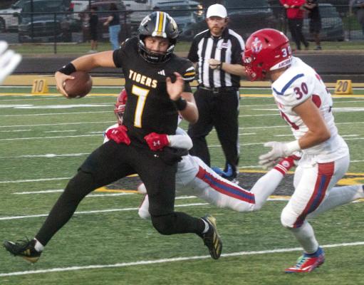 Sealy junior quarterback Kane Killough attempts to break away from a pair of Brazosport defenders during last Friday’s win. Killough passed for 225 yards and a touchdown in the victory. Sealy will travel to Bay City Friday to take on the Blackcats. Photo by Jimmy Galvan