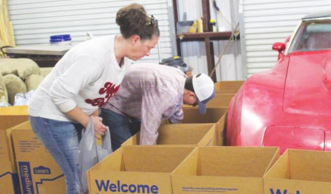 Joell and Christopher Prado ensured each box contained the correct items for a Thanksgiving meal. PHOTOS BY HANS LAMMEMAN