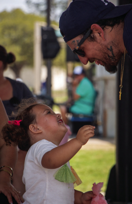 Grace Geer shares cotton candy with her father Mattew during First United Methodist Church’s 15th annual Easter Eggstravaganza, Sunday, March 29, at Sealy B&amp;PW Park. ALL PHOTOS BY THE SEALY NEWS | ALLISON DRINNON