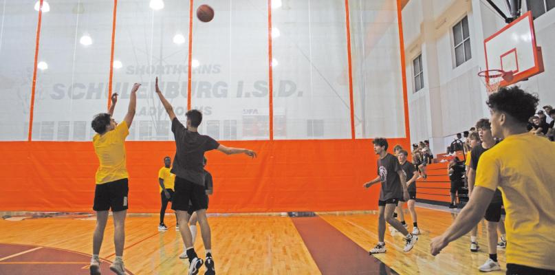 Sealy High School Tigers point guard Ryder Ramirez rises for a 3-point shot over a Fayetteville Lions defender in the Schulenburg Hoops League single-elimination playoff tournament June 29. JASON MANAGO-GRAVES