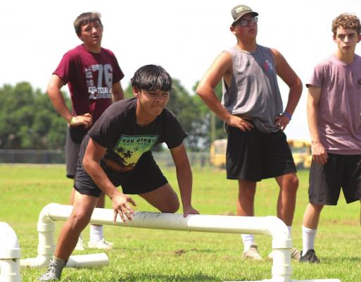 Matthew Maldonado hurdles over a dummy to pursue a tackle during the Brazos Cougar Football Camp Monday, July 26. COLE McNANNA