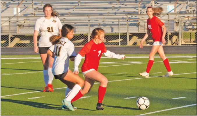 Sealy’s Julieta Villagomez (11) battles a Bellville defender during last Friday’s game for a loose ball. PHOTOS BY JIMMY GALVAN