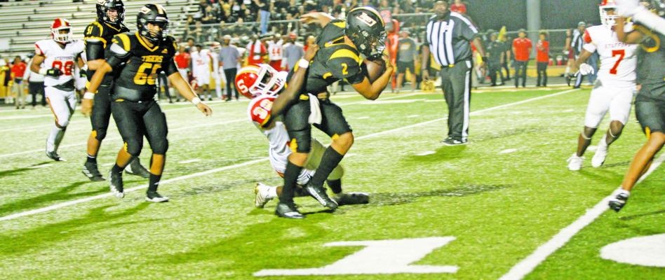 Sealy High School quarterback D’Vonne Hmielewski drags a Stafford Spartan with him while fighting to get to the end zone during the Sept. 9 game. BRACKSTON NUTT