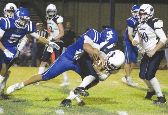 PHOTOS BY COLE McNANNA Faith Academy senior Nathan Figueroa delivers a hit to a Northside ballcarrier during the regular season meeting Sept. 10 at SAB Stadium in Bellville. The Knights and Lions will meet once again Saturday with a State Championship on the line.