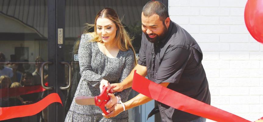 Sealy Appliance Center owners Oswaldo and Caricia Marroquin cut the ribbon as part of grand-opening festivities outside the store Saturday, Sept. 18. PHOTOS BY COLE McNANNA