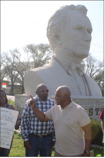 Hershal Walker and Rev. J.R. Johnson of Seeking Justice stand in front of the Stephen F. Austin statue on Hwy. 36 in Bellville protesting the statue and seeking a similar honor for Martin Luther King. PHOTO BY JIMMY GALVAN