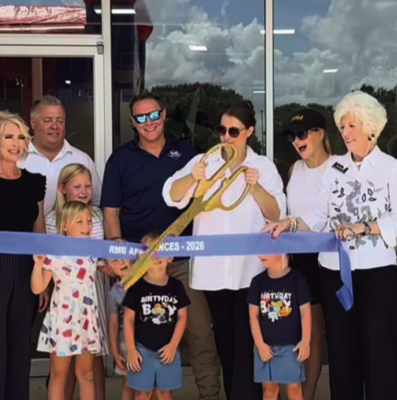 From left: Claudia Batton, Vince Wollney, owner Ross McDowell, owner Mary Beth McDowell and Toni Franklin cut the ribbon as family friend and youngsters look on at the June 12 grand opening of RMB Appliances in Sealy. COURTESY PHOTOS