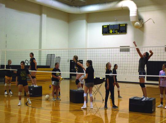 The Sealy volleyball teams are also hard at work for the upcoming season. Below, first-year head coach Caroline Owen addresses her teams during the first day of workouts. PHOTOS BY ABENEZER YONAS.