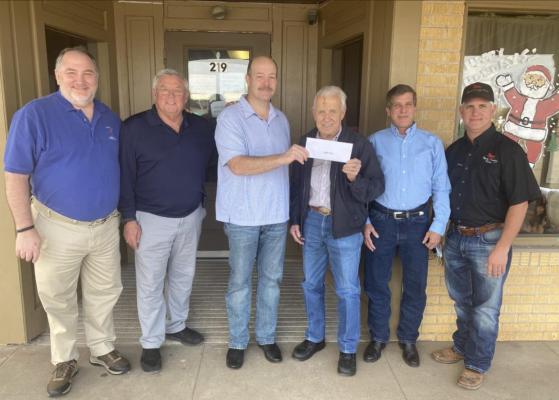 David Cryan, fourth from left, donated the building on Front Street to the Sealy Ministerial Alliance to allow it to continue to operate The Good Samaritan Shop. Pictured from the left are the Rev. Michael Fraley (First United Methodist Church), Deacon Robert Kent (Immaculate Conception Catholic Church), Ralph Bond (First Baptist Church), David Cryan, Ken Cryan, and Stephen Cryan. Courtesy photo