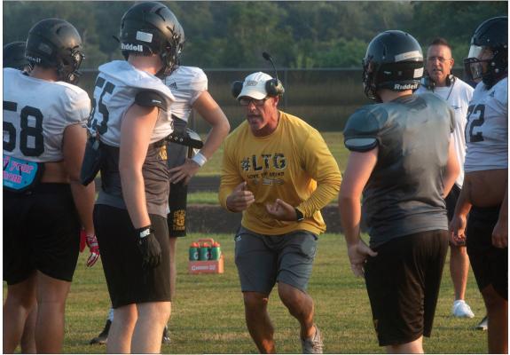Sealy Head Football Coach Clint Finley addresses the offensive linemen during the first day of practice in pads last week. Finley believes that even though the sguad lost several key members of its offensive line to graduation, the team wil I replace those players just fine this year.